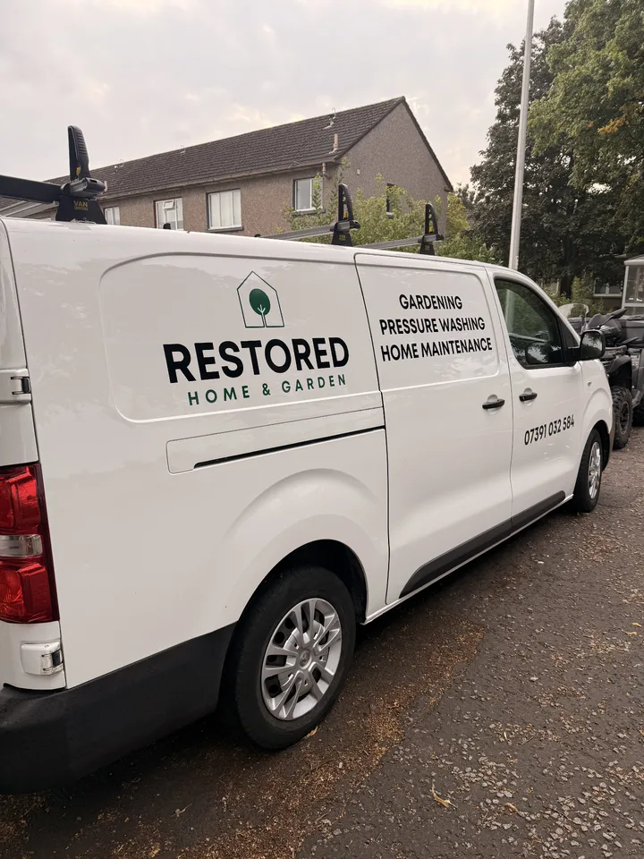 Black and green home and garden graphics on the side of a white Vauxhall Vivaro van